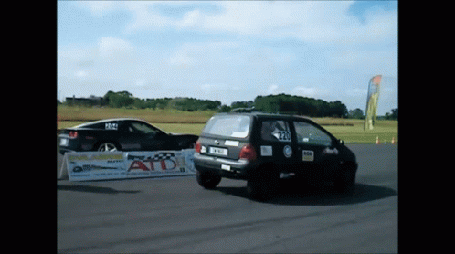 Two Cars Racing On Track With ATD Sign GIF