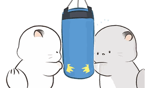 two cartoon cats are standing next to a blue boxing bag