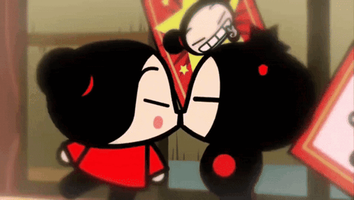 Two Cartoon Characters Are Kissing Each Other In Front Of A Sign . GIF