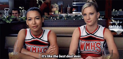 Two Cheerleaders From Wmhs Are Sitting Next To Each Other In A Diner GIF
