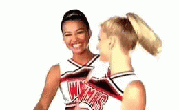 Two Cheerleaders Talking And Smiling GIF