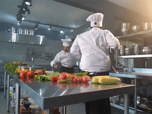 Two Chefs Cooking with Vegetables