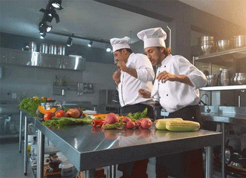 Two Chefs Preparing Food with Vegetables