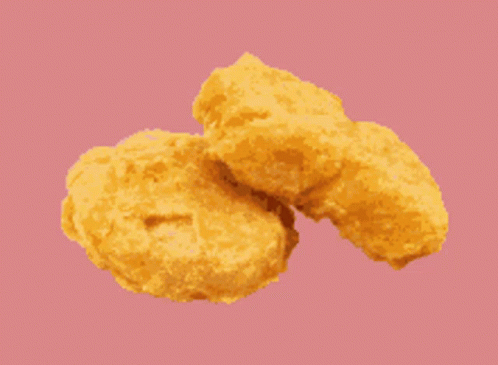 Two Chicken Nuggets On A Green Background GIF