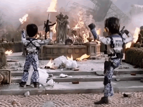 Two Children in Police Uniforms Before Burning Building