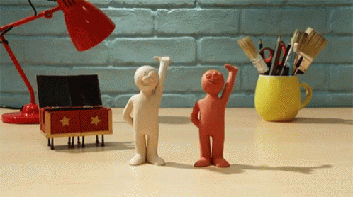 Two Clay Figures Standing Together