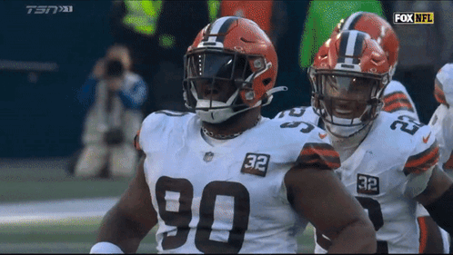 Two Cleveland Browns Players Number 90 And 32 GIF