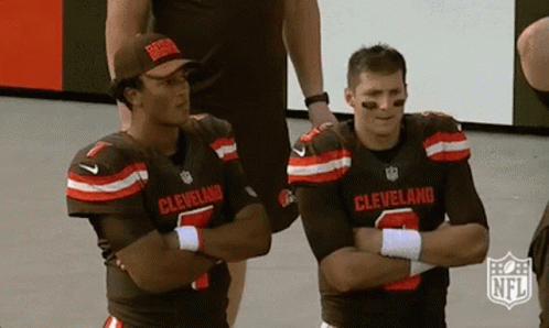 Two Cleveland Football Players Standing Crossed Arms