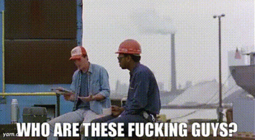 Two Construction Workers Are Sitting Next To Each Other In Front Of A Building . GIF