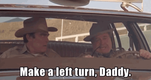 Two Cowboy Hat Men Saying Make Left Turn Driving GIF