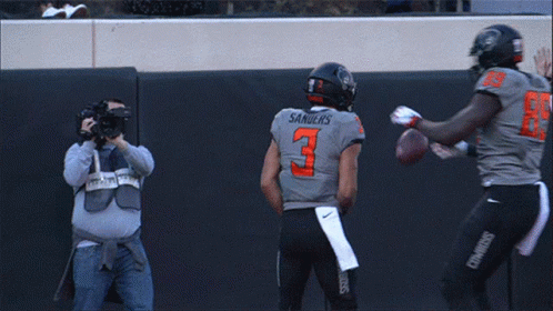 Two Cowboys Football Players Celebrate A Touchdown With A Referee GIF
