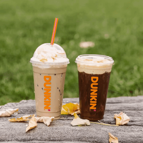 Two Cups Of Dunkin ' Coffee Are On A Table GIF