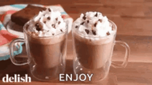 Two Cups Of Hot Chocolate With Whipped Cream And Chocolate Chips GIF