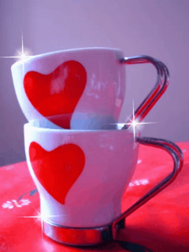 Two Cups With Red Hearts Stacked on Table