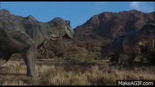 Two Dinosaurs Are Standing Next To Each Other In A Field In Front Of Mountains . GIF