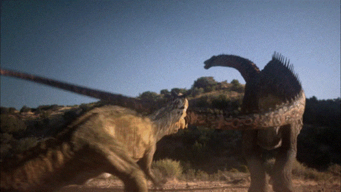 Two Dinosaurs Beside Trees GIF