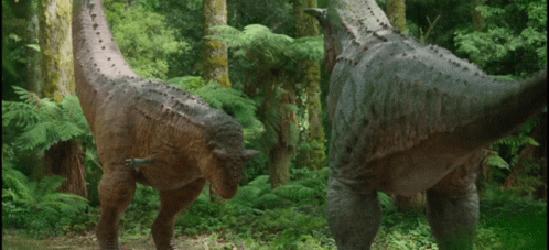 Two Dinosaurs Standing in Forest