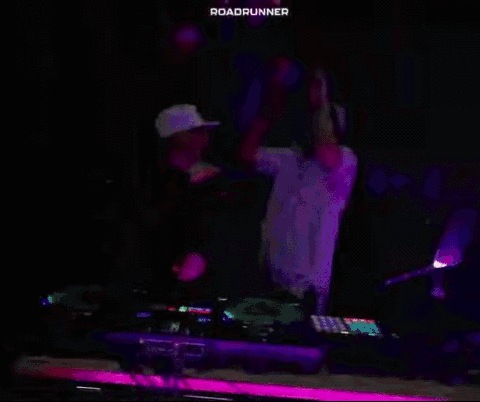 Two Dj 'S Are Dancing In Front Of A Crowd And The Word Roadrunner Is On The Purple Background GIF