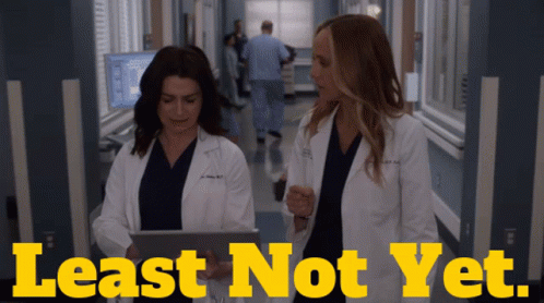 Two Doctors In A Hospital Hallway With The Words Least Not Yet On The Bottom GIF