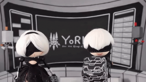 Two Dolls in Front of Screen Saying Yor