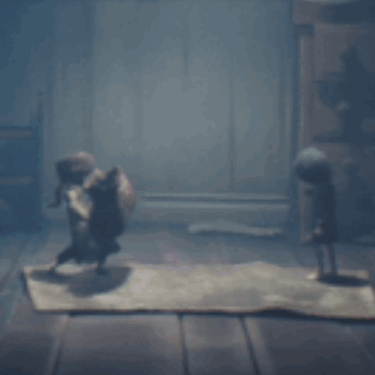 Two Dolls Standing on Rug in Dark Room
