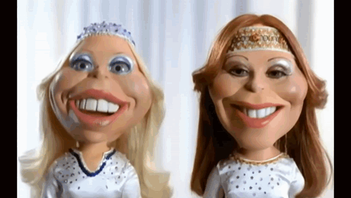 Two Dolls With Big Smiles On Their Faces Are Standing Next To Each Other On A White Background . GIF