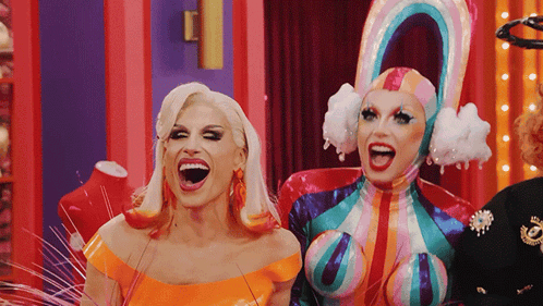 Two Drag Queens Are Standing Next To Each Other With Their Mouth Open GIF
