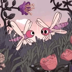 Two Dragonflies Flying Over Flowers GIF