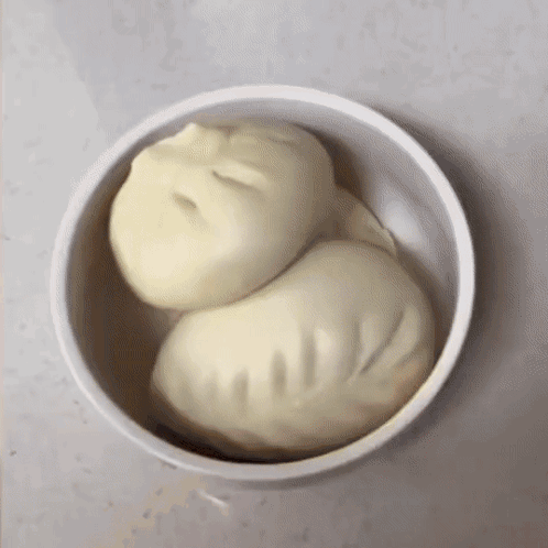 Two Dumplings In A Bowl That Looks Like A Person 'S Face GIF
