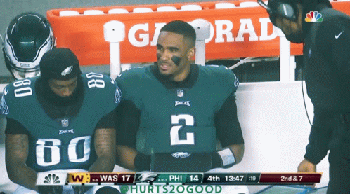 Two Eagles Players on Sidelines With Gatorade Cooler