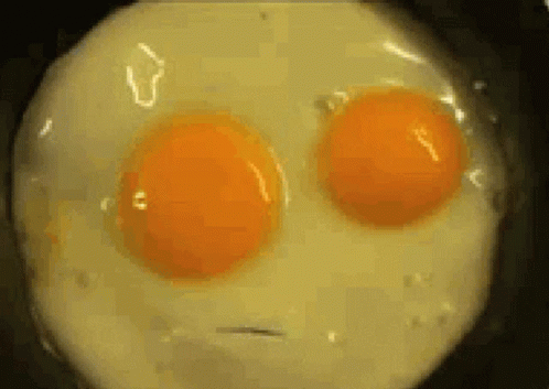 Two Eggs in Pan Looking Like Face