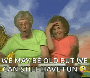 Two Elderly Women Are Sitting Next To Each Other On A Bench With The Caption `` We May Be Old But We Can Still Have Fun GIF