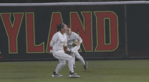Two Female Baseball Players Running Cleveland Banner