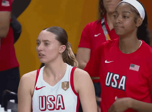 two female basketball players wearing usa uniforms