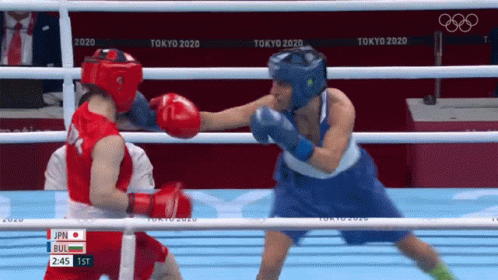 Two Female Boxers Are Fighting In A Boxing Ring At The Olympics . GIF
