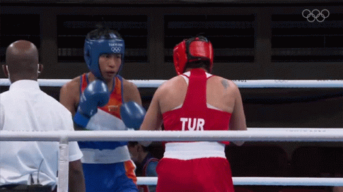 Two Female Boxers In A Ring One Of Whom Is Wearing A Tur Shirt GIF