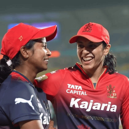 Two Female Cricket Players Are Standing Next To Each Other On The Field And Smiling . GIF