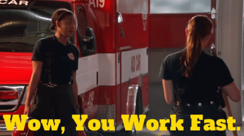 Two Female Firefighters in Front of Ambulance