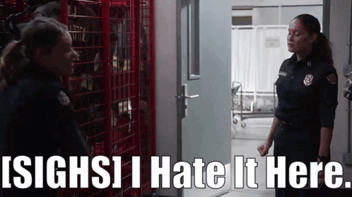 Two Female Firefighters Standing Next To Each Other With The Words ' Sighs I Hate It Here ' Above Them GIF