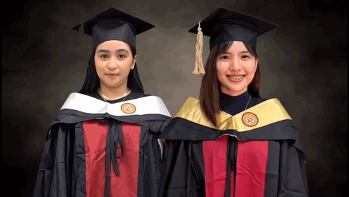 Two Female Graduates Standing GIF