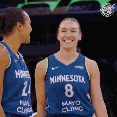 Two Female Minnesota Basketball Players Are Smiling And Looking At Each Other GIF
