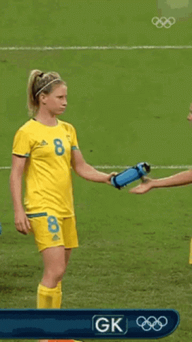 Two Female Soccer Players Drinking Water From Bottles GIF