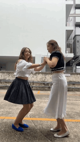 Two Female Soccer Players Hugging on Field with TDP