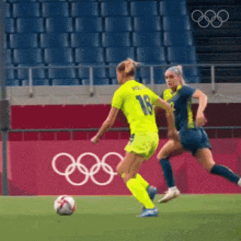 Two Female Soccer Players Playing with Olympic Rings