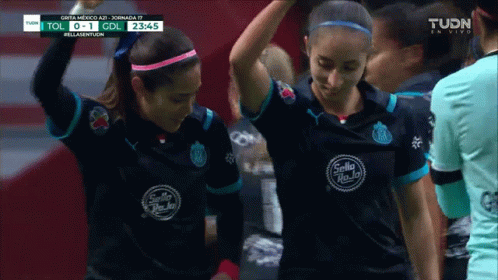 Two Female Soccer Players Wearing Black Sello Shirts