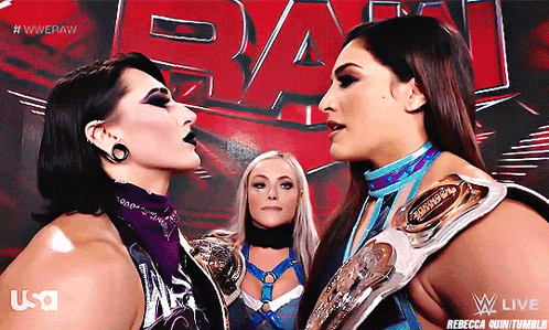 Two Female Wrestlers Face Each Other In Front Of A Wwe Logo GIF