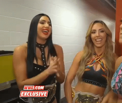 Two Female Wrestlers Smiling Next To Each Other GIF
