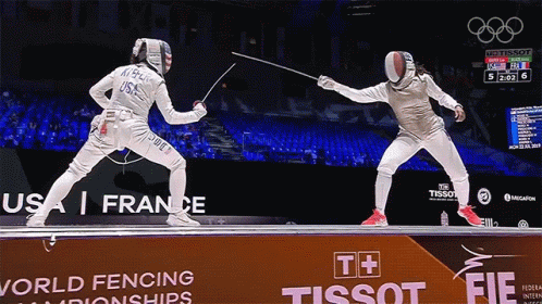 Two Fencers Are Fighting In Front Of A Tissot Sign GIF