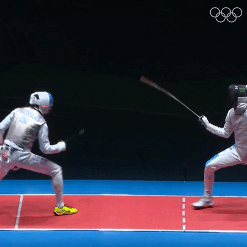 Two Fencers Are Fighting On A Red Court With The Olympics Logo In The Background GIF