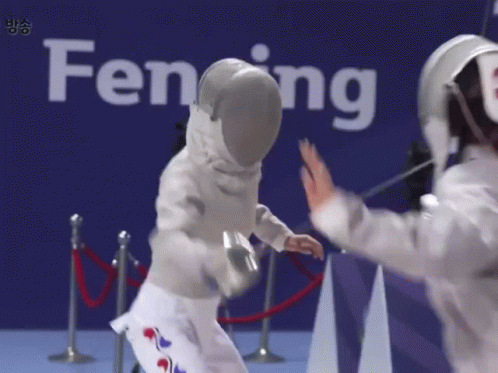 Two Fencers Are Giving Each Other High Fives In Front Of A Sign That Says Fencing GIF